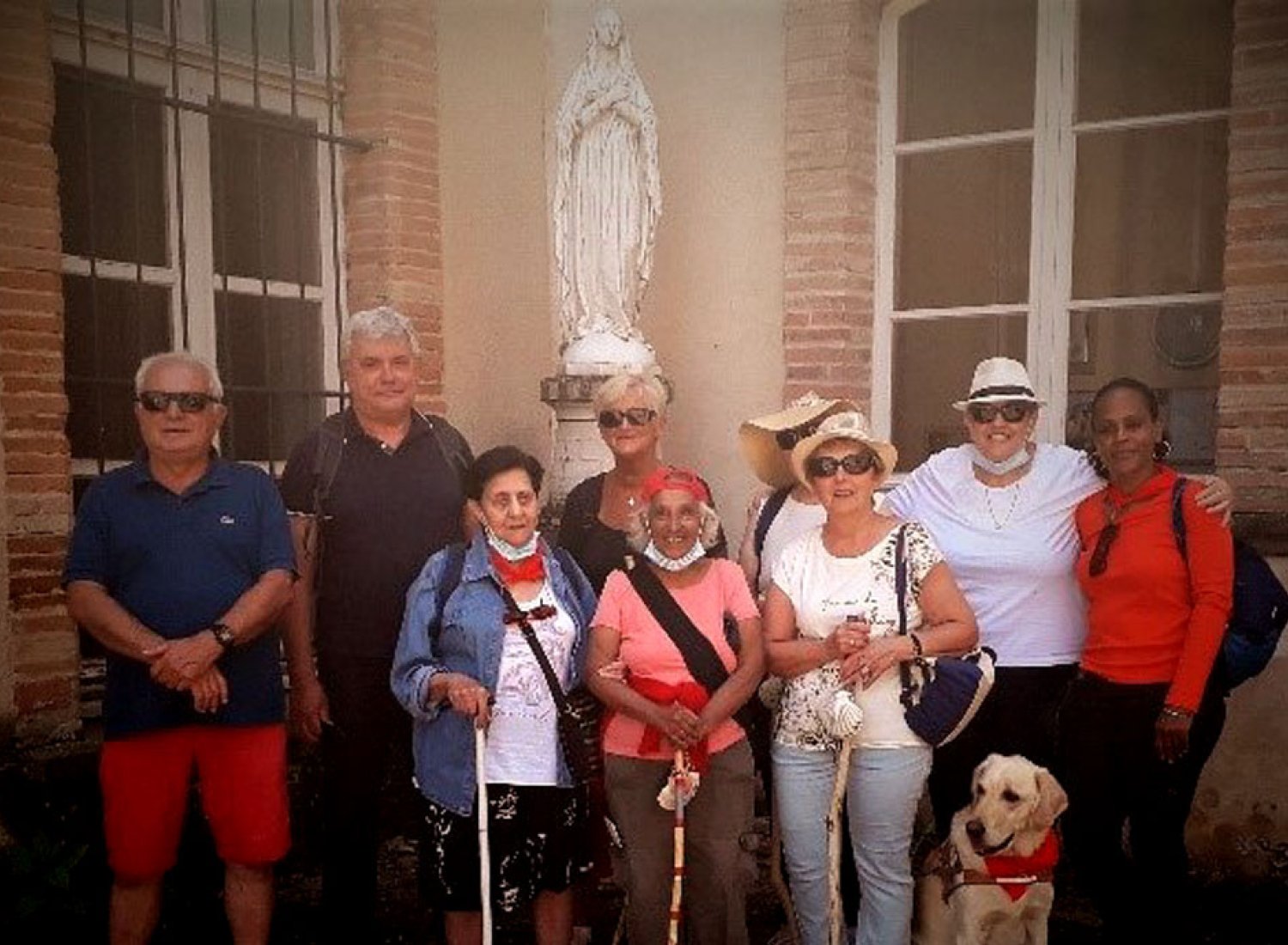 Le groupe de marcheurs devant une statue de la Saint Vierge.